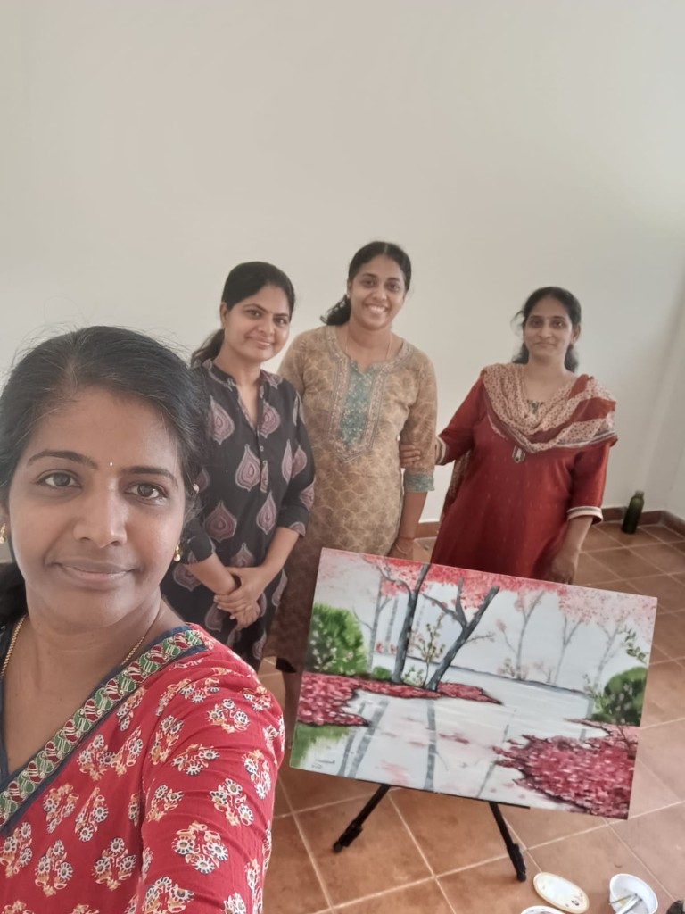 Artists presenting a completed landscape painting in class