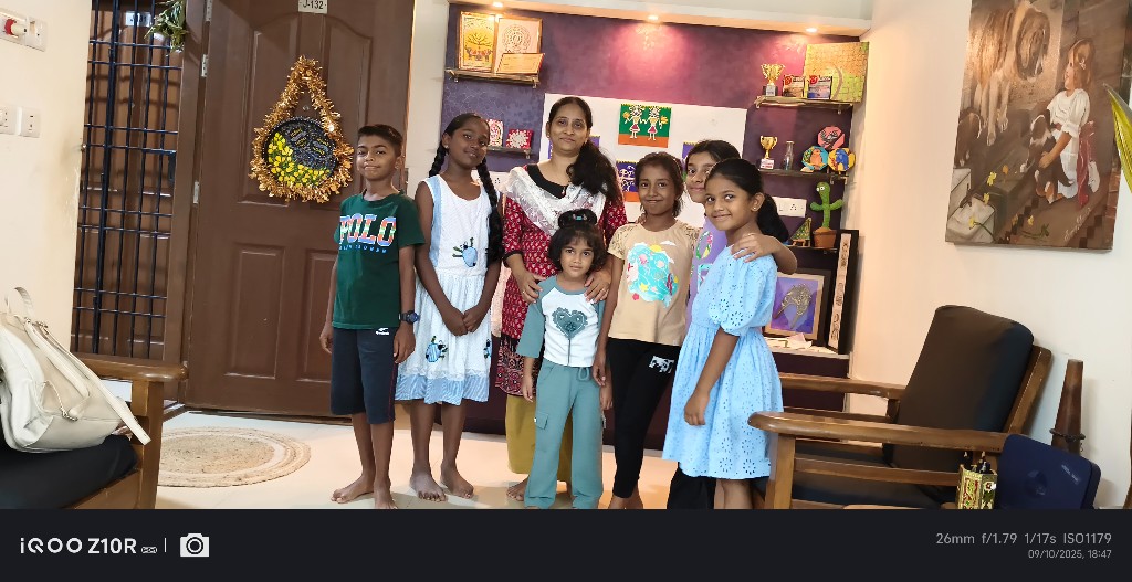 Children posing with their instructor after an art class